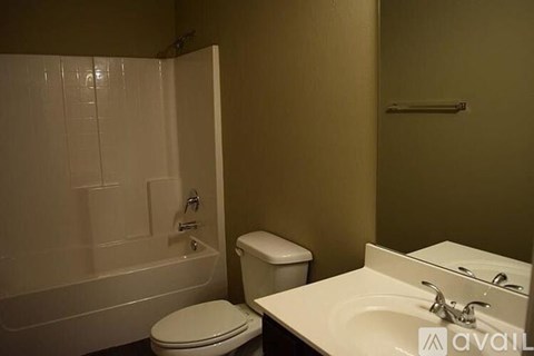 A bathroom with a toilet, sink, and bathtub.