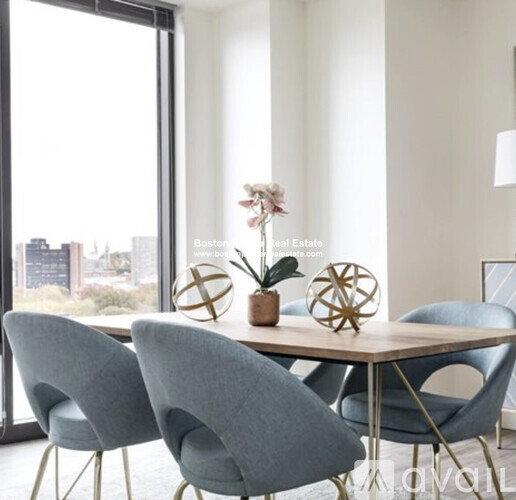 A modern dining room with a table and chairs.