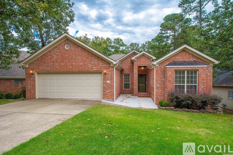 A brick house with a garage and a driveway.