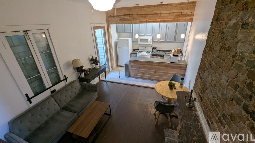 A living room with a grey couch and a wooden table.