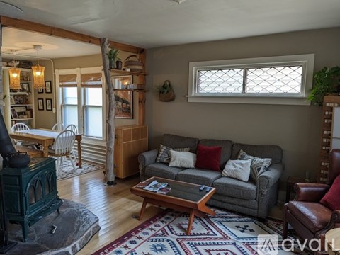 A living room with a grey couch and a wooden coffee table.