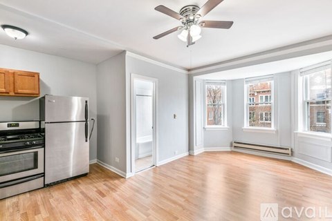 A kitchen with a refrigerator, stove, and oven.