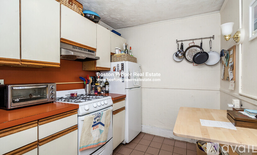 A kitchen with a stove top oven and a microwave.