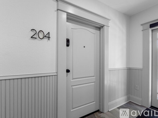A white door with the number 204 on the wall above it.