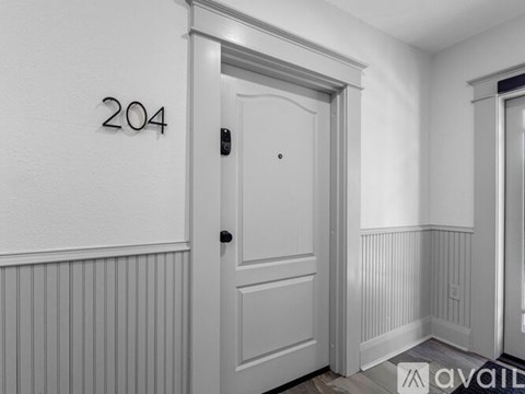A white door with the number 204 on the wall above it.