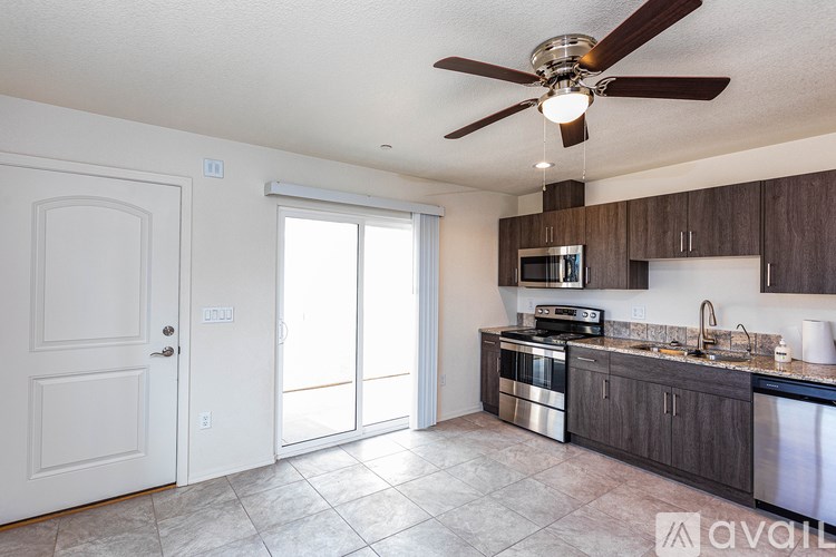 A kitchen with a fan and a sink.