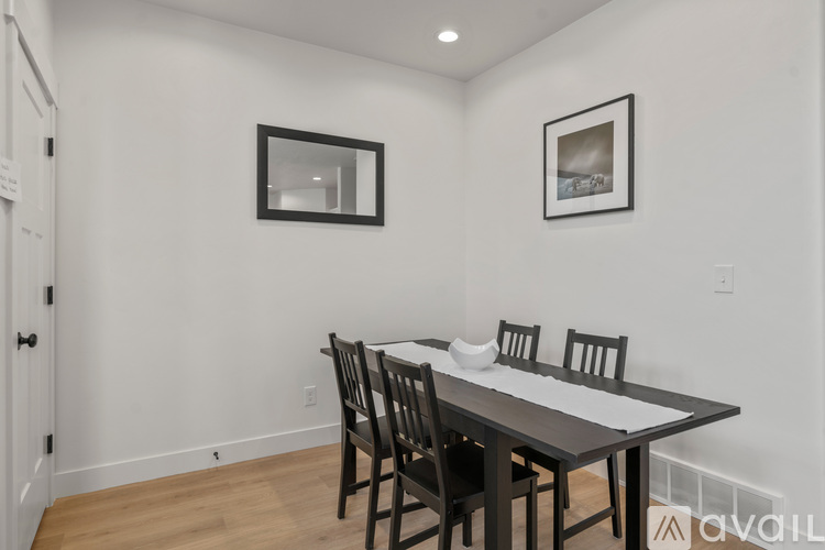 A dining room with a table and chairs.
