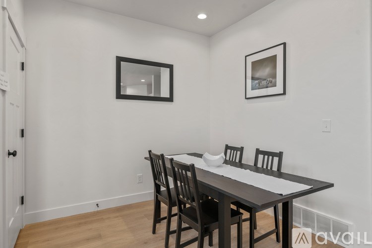 A dining room with a table and chairs.
