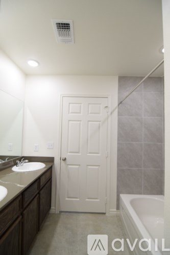 A bathroom with a white door and a white sink.