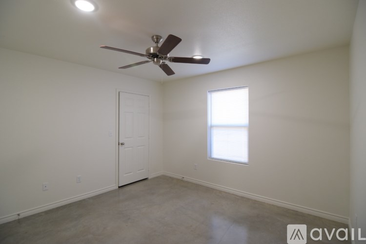 A room with a ceiling fan and a window.