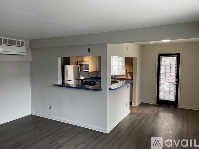 A kitchen area with a refrigerator, stove, and sink.