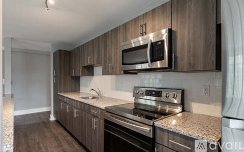 A kitchen with a microwave and oven built into the cabinetry.