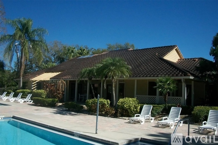 A house with a pool in front of it.