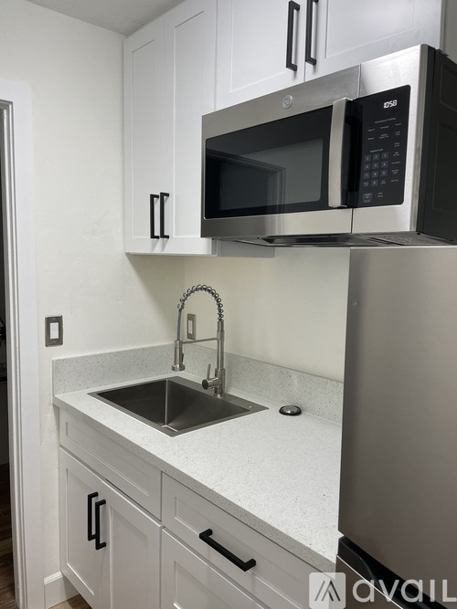 A kitchen with a sink and a microwave above it.