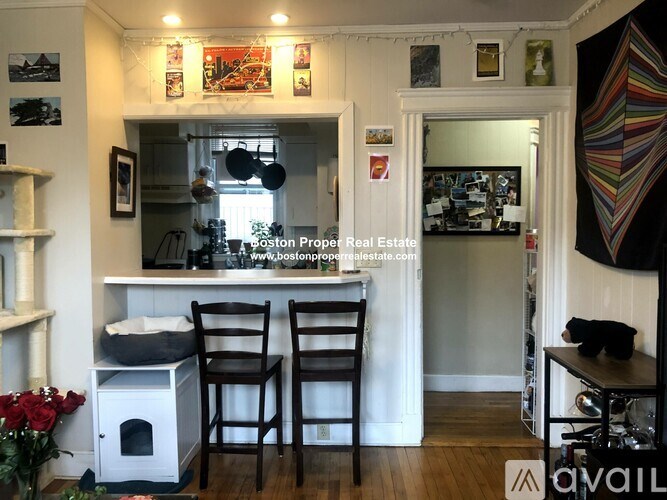 A kitchen with a white counter top and two chairs.