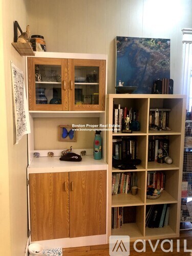 A room with a bookshelf and a cabinet.