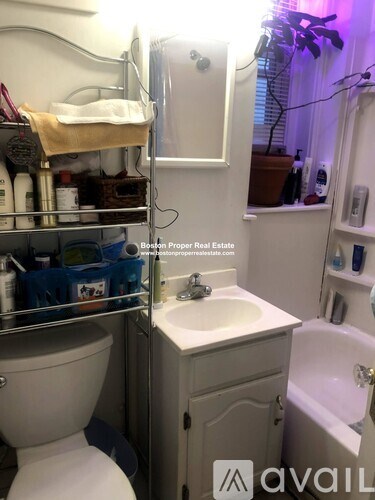 A small bathroom with a toilet, sink, and bathtub.