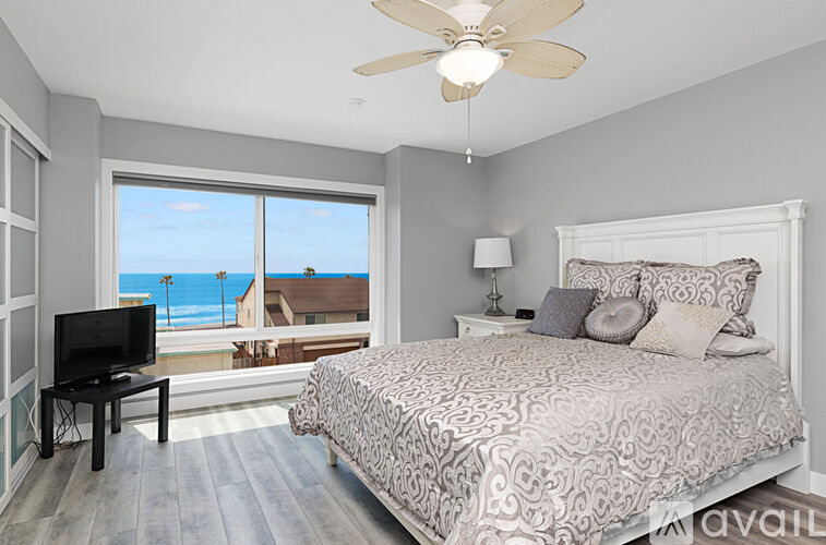A bedroom with a large bed and a television.