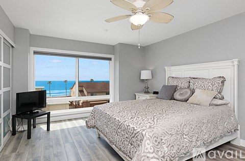 A bedroom with a large bed and a television.