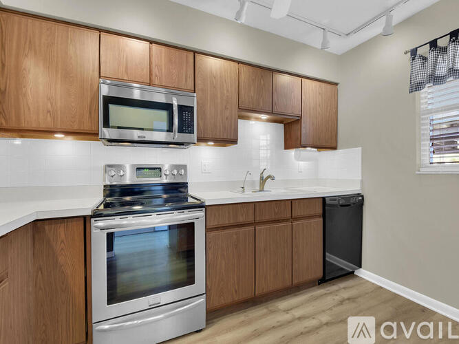 A kitchen with wooden cabinets and stainless steel appliances.