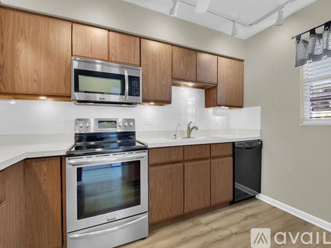 A kitchen with wooden cabinets and stainless steel appliances.