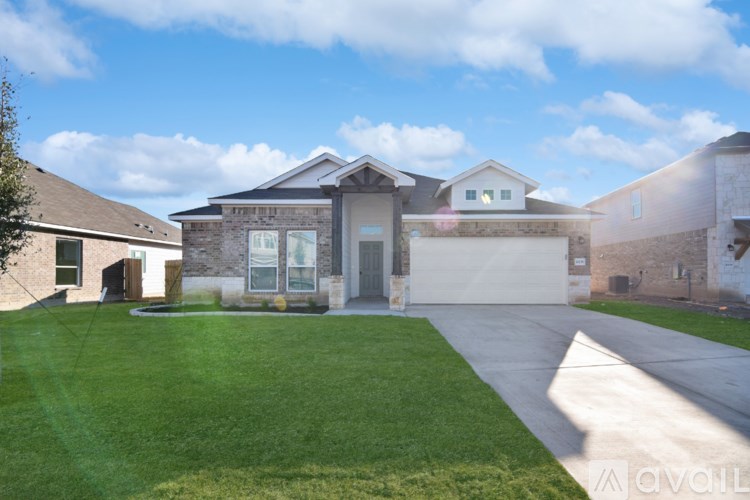 A house with a driveway and garage is available for sale.