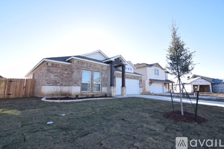 A house with a tree in front of it and a sign that says "available".