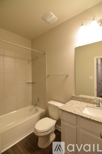 A bathroom with a toilet, sink, and bathtub.