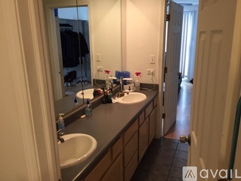 A bathroom with two sinks and a large mirror.
