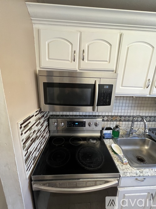A kitchen with a stove top oven and microwave.