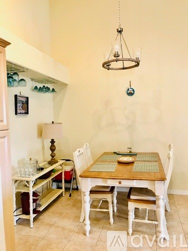 A dining room with a table set for four.