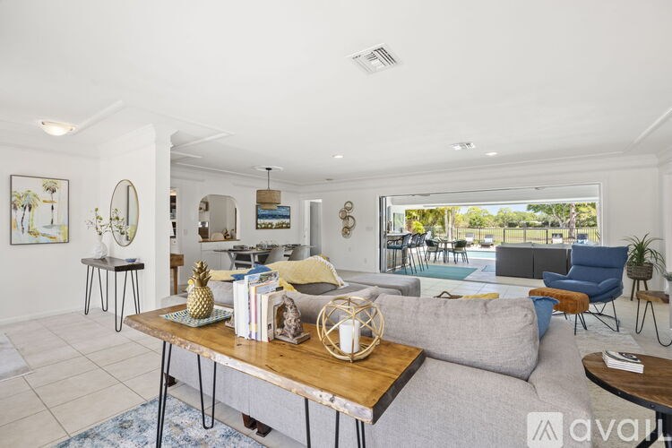 A living room with a grey couch and a wooden coffee table.