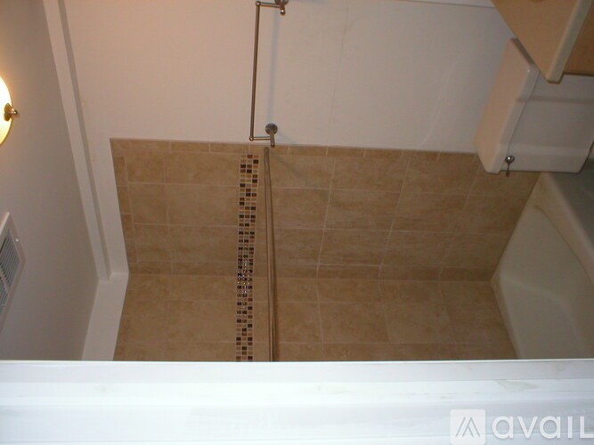 A bathroom with a tiled shower area.