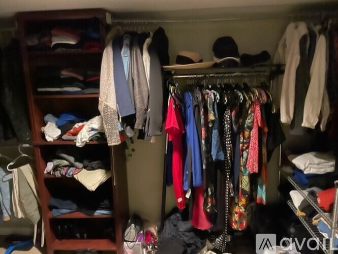 A closet full of clothes and a shoe rack.
