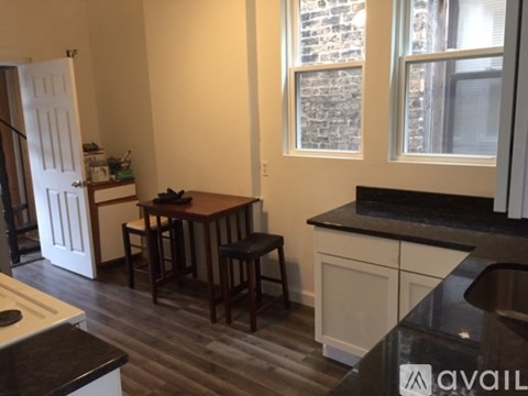 A kitchen with a table and chairs in the middle of it.