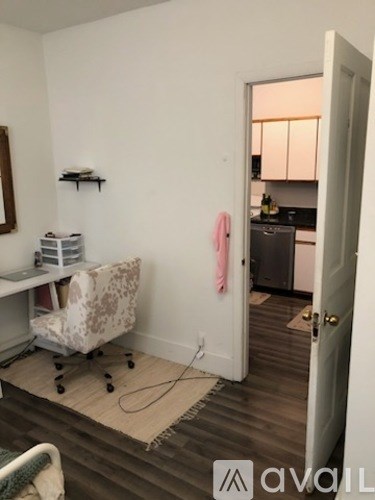 A room with a chair and a desk in it.