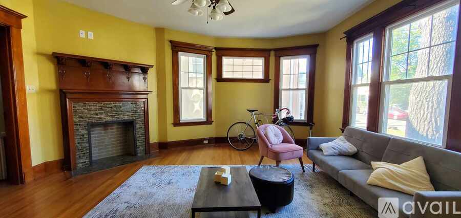 A living room with a fireplace and a bicycle.