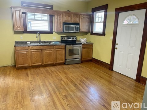 A kitchen with wooden cabinets and a white door.