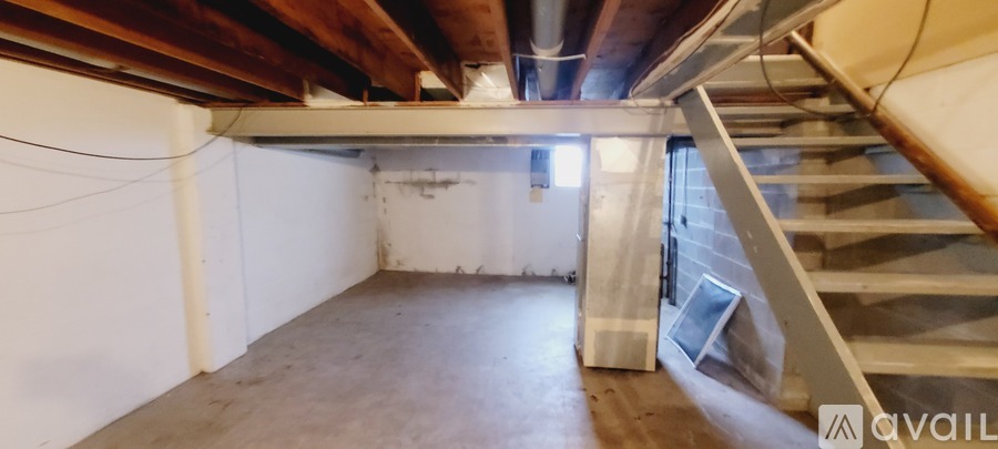 A room with a staircase leading to the upper floor.