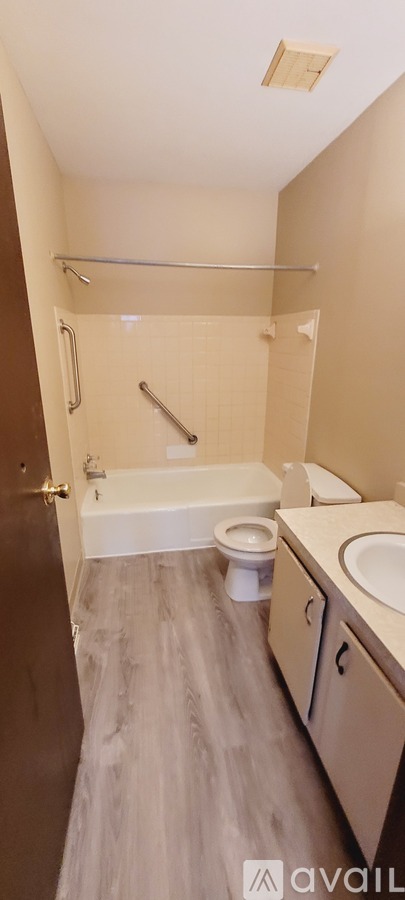 A bathroom with a toilet, sink, and shower.