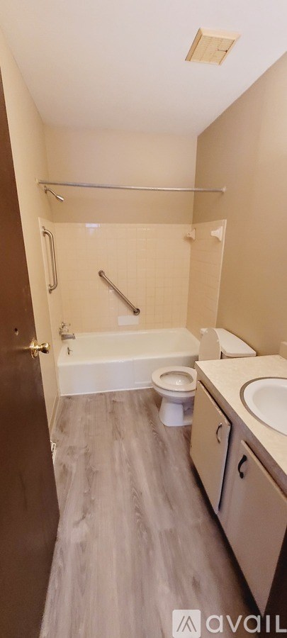 A bathroom with a toilet, sink, and shower.
