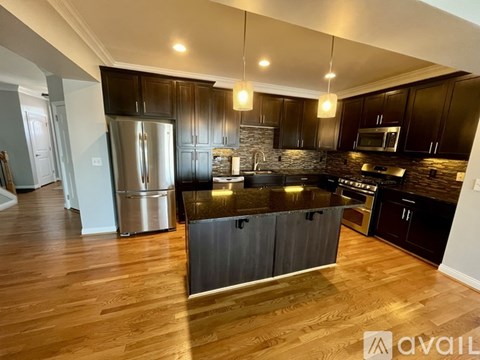 A kitchen with dark wood cabinets and a central island.