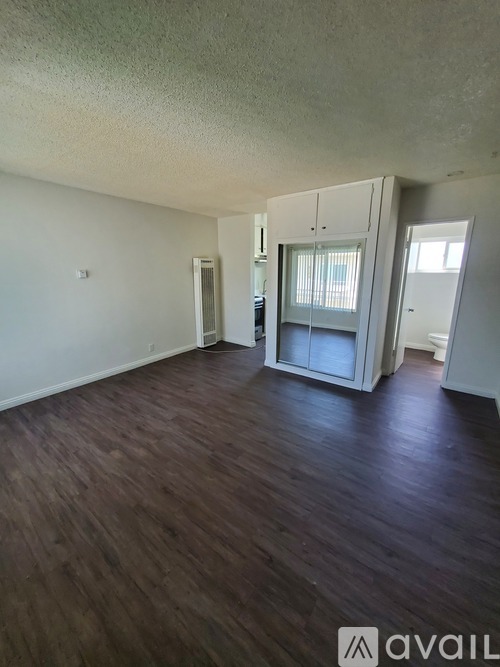 A room with wooden floors and white walls.