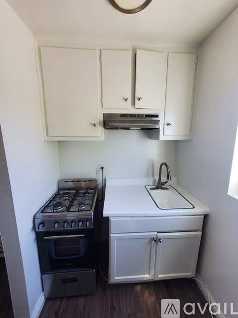 A small kitchen with a stove and sink.