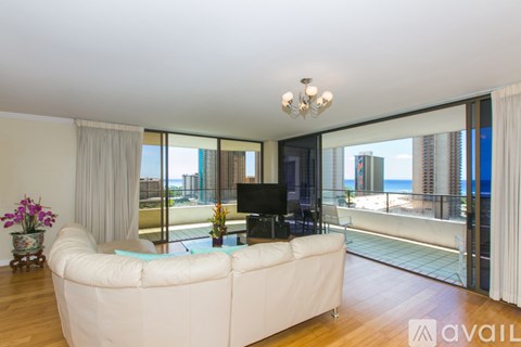 A living room with a white couch and a television.