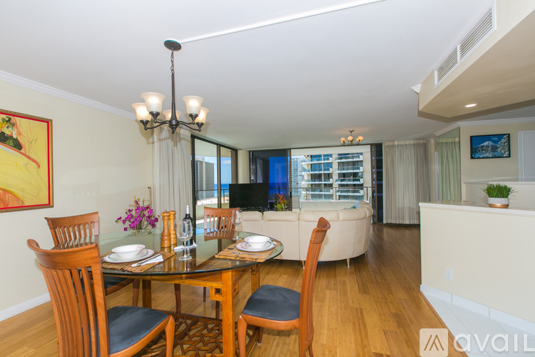A dining room with a glass table and chairs.