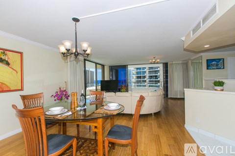 A dining room with a glass table and chairs.