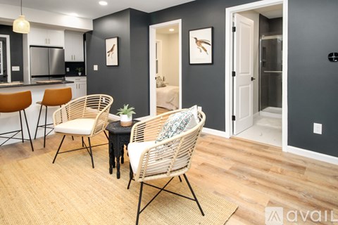 A living room with a dining table and chairs.