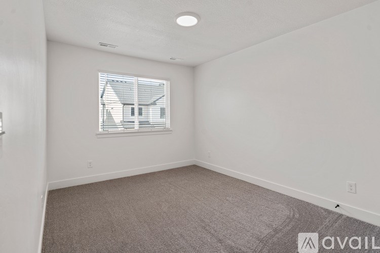 A room with a window and carpeted floor.