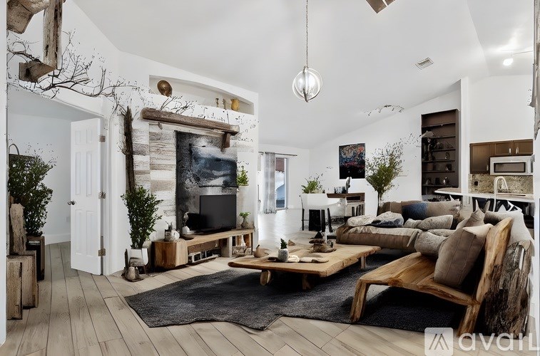 A modern living room with a fireplace and a large couch.